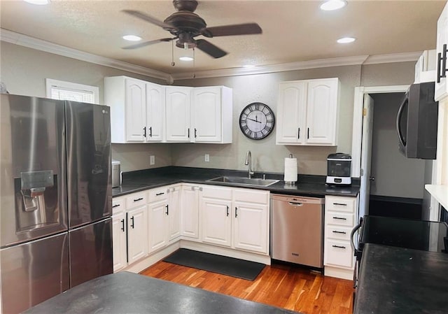 kitchen featuring white cabinets, stainless steel appliances, and sink