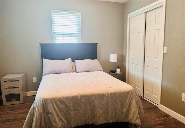 bedroom featuring dark hardwood / wood-style flooring and a closet