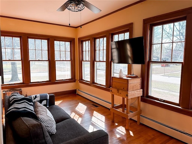 living room featuring crown molding, ceiling fan, and light wood-type flooring