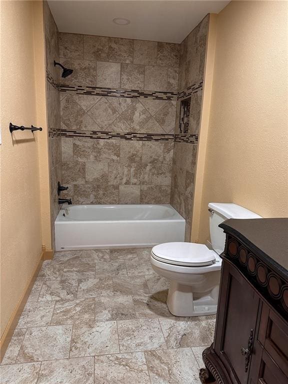 full bathroom featuring vanity, toilet, and tiled shower / bath