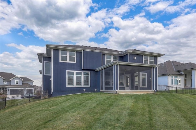 back of house featuring a sunroom and a yard