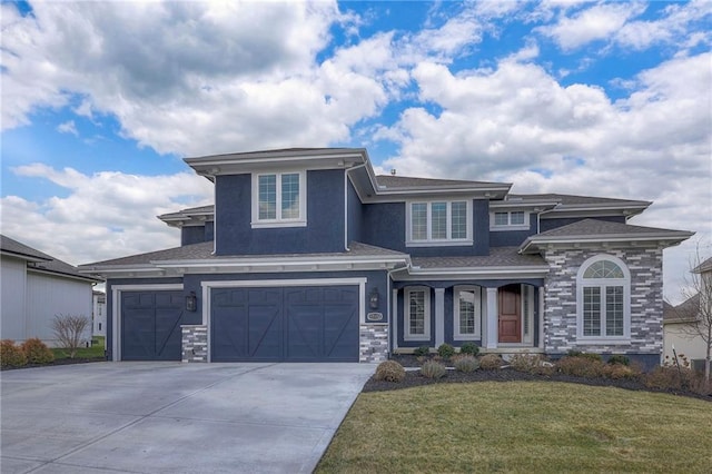 prairie-style home with a garage and a front yard