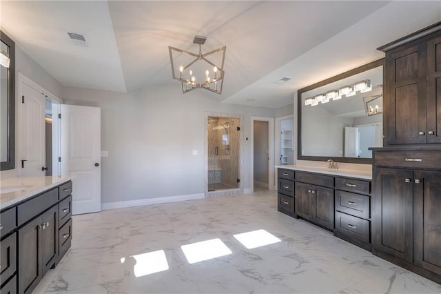 bathroom featuring a chandelier, vanity, an enclosed shower, and lofted ceiling