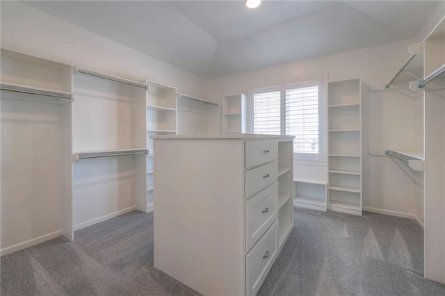 walk in closet featuring dark carpet and vaulted ceiling