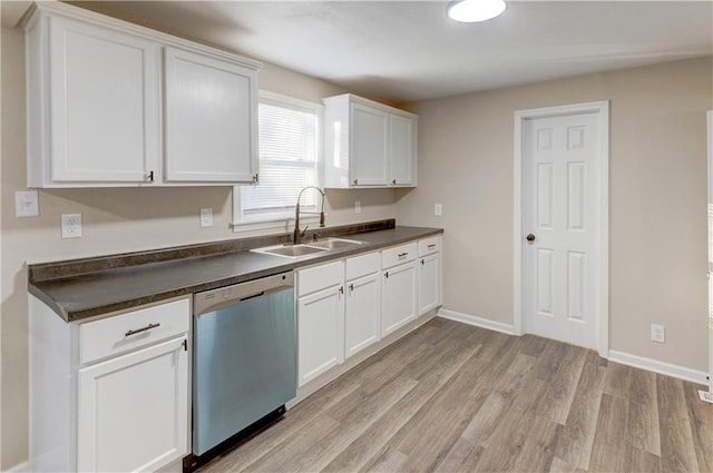 kitchen with stainless steel dishwasher, white cabinets, light wood-type flooring, and sink