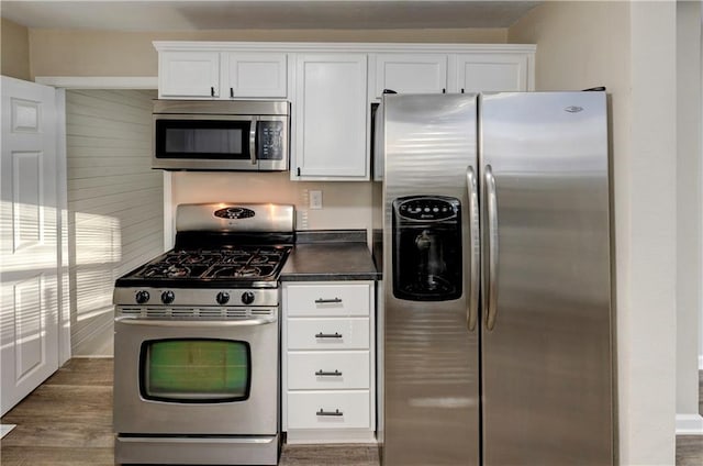 kitchen with white cabinetry, dark wood-type flooring, and appliances with stainless steel finishes