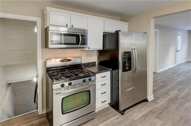 kitchen featuring white cabinets, stainless steel appliances, and light hardwood / wood-style floors