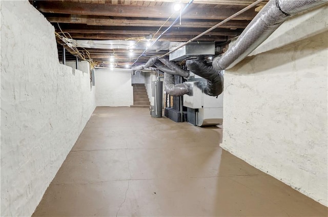 basement featuring gas water heater and heating unit