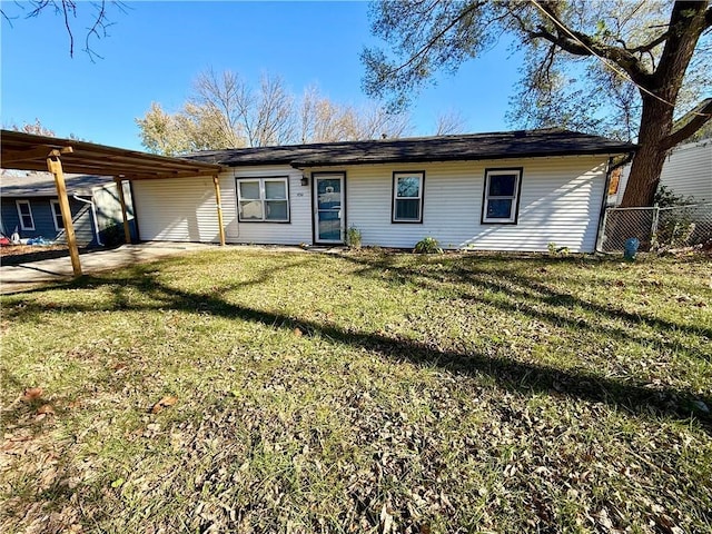 single story home featuring a carport and a front lawn