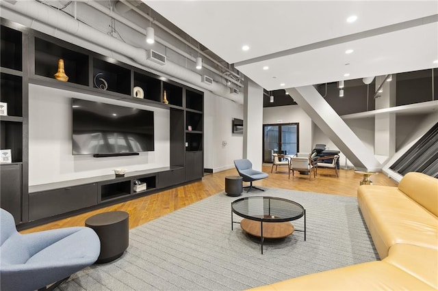 living room featuring hardwood / wood-style floors and built in features