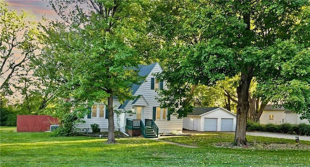 view of property hidden behind natural elements with an outbuilding, a yard, and a garage