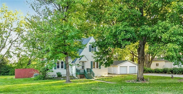 obstructed view of property featuring a garage, an outdoor structure, and a front lawn