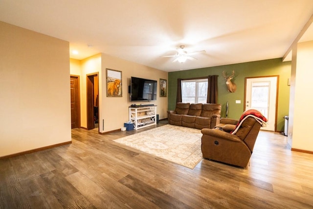 living room featuring ceiling fan and light hardwood / wood-style flooring