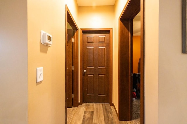 corridor with light hardwood / wood-style flooring