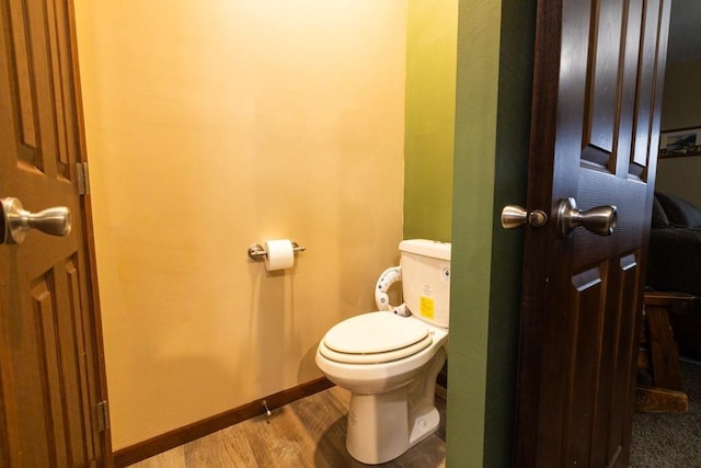 bathroom featuring hardwood / wood-style floors and toilet