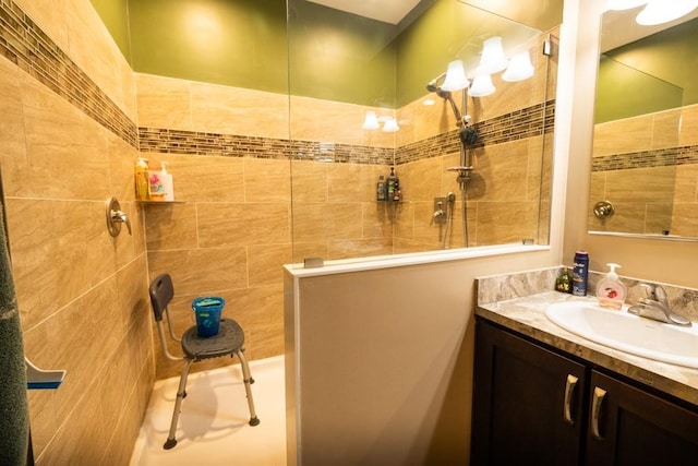 bathroom with vanity and tiled shower