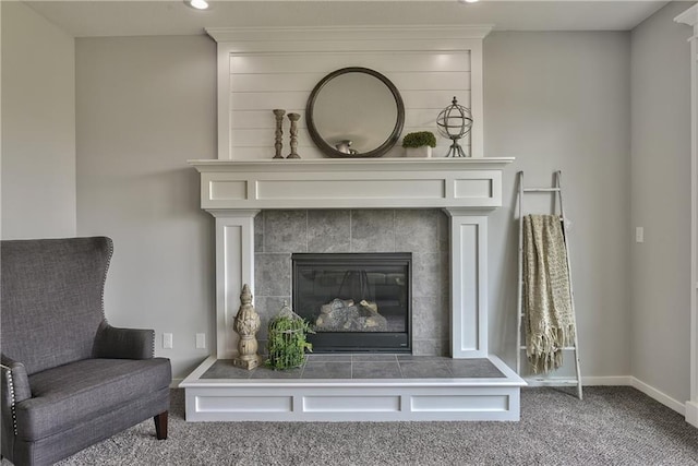 living area featuring a fireplace and carpet