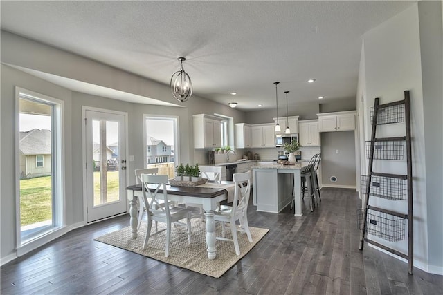 dining area featuring dark hardwood / wood-style floors, an inviting chandelier, and sink