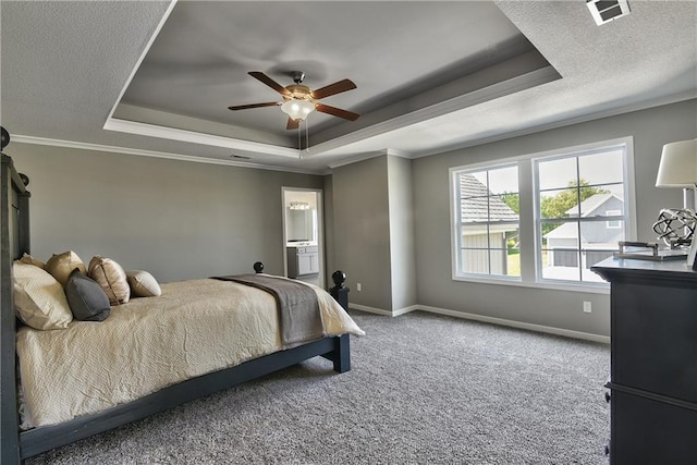 carpeted bedroom with a raised ceiling, ceiling fan, and ornamental molding