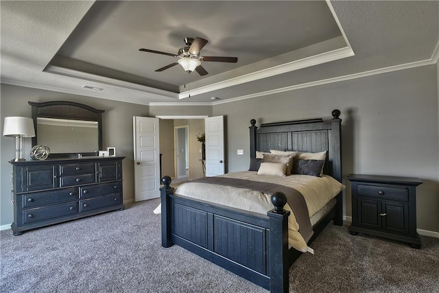 bedroom featuring a raised ceiling, ceiling fan, and dark colored carpet