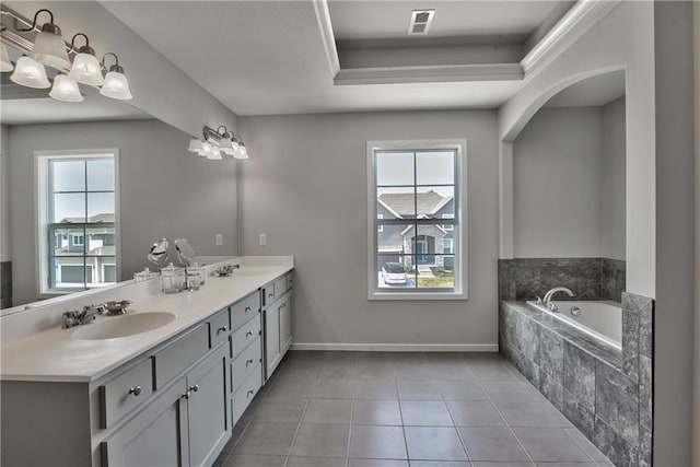 bathroom with tile patterned flooring, vanity, and a wealth of natural light