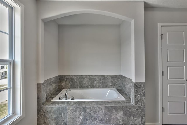 bathroom with tiled tub