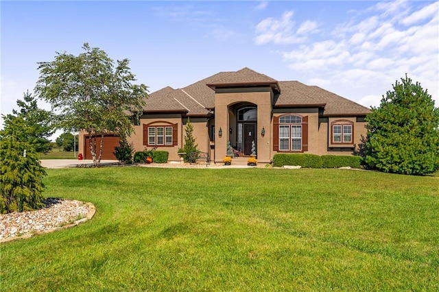 view of front of home with a garage and a front lawn