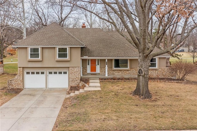 split level home with a garage and a front lawn