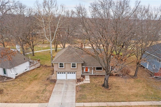 view of front of house with a garage and a front lawn