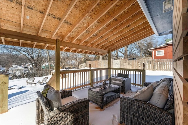 snow covered deck featuring a patio and an outdoor hangout area