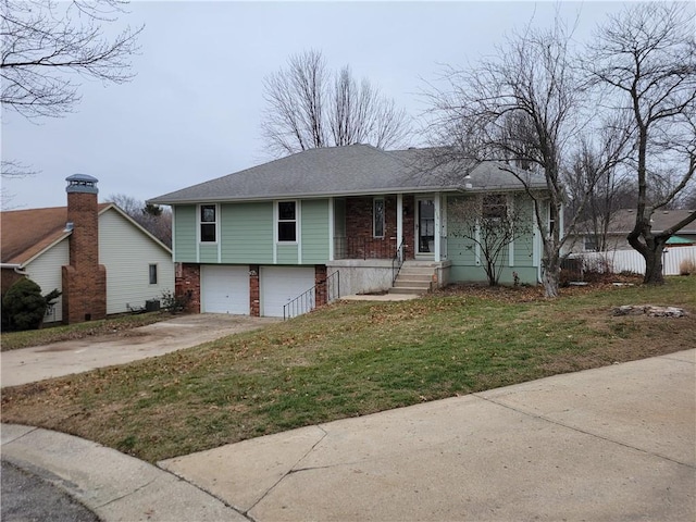 view of front of property featuring a garage and a front lawn