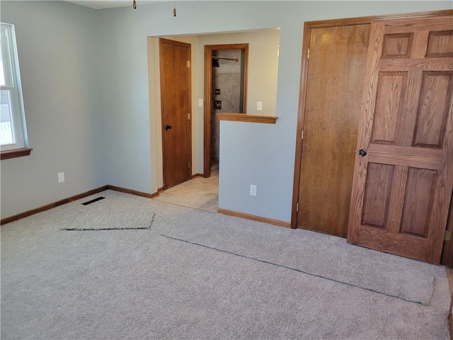 unfurnished bedroom featuring light colored carpet