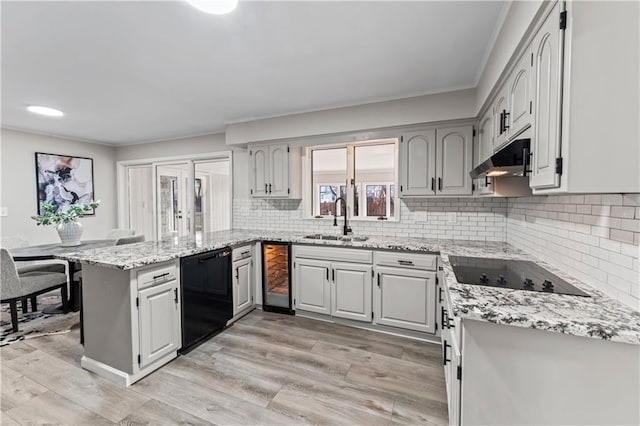 kitchen with gray cabinetry, wine cooler, black appliances, and kitchen peninsula