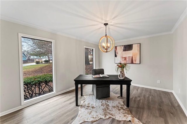 home office with hardwood / wood-style flooring, ornamental molding, and an inviting chandelier