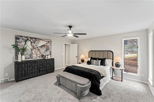 bedroom with ornamental molding, light colored carpet, and ceiling fan