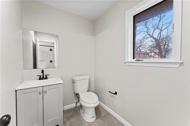 bathroom with vanity, tile patterned flooring, and toilet