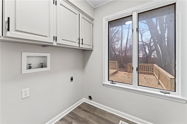 washroom with dark wood-type flooring, hookup for a washing machine, cabinets, ornamental molding, and hookup for an electric dryer