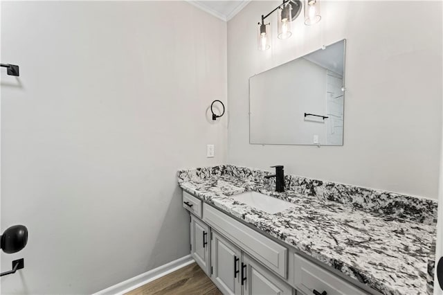 bathroom featuring vanity, hardwood / wood-style floors, and crown molding