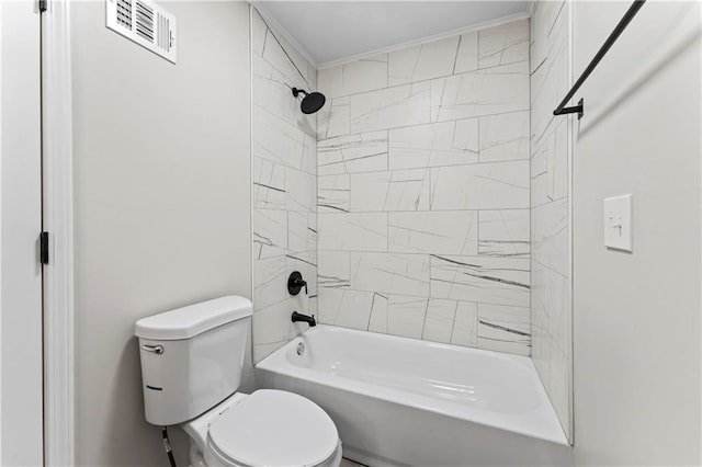 bathroom featuring tiled shower / bath and toilet