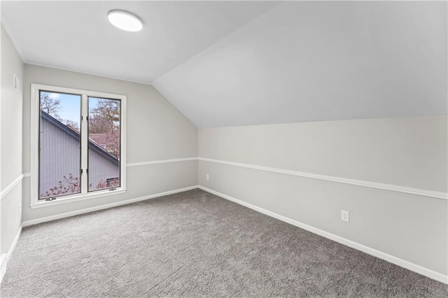 bonus room featuring carpet floors and vaulted ceiling