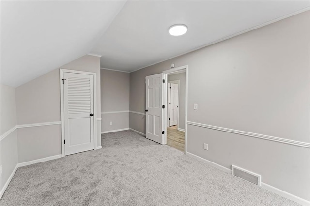 bonus room featuring light colored carpet and lofted ceiling