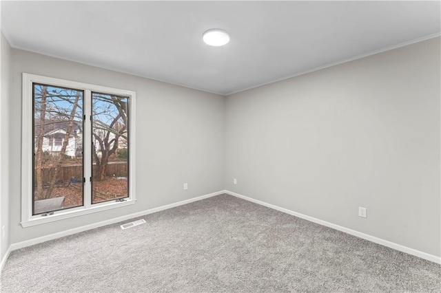 carpeted empty room with ornamental molding