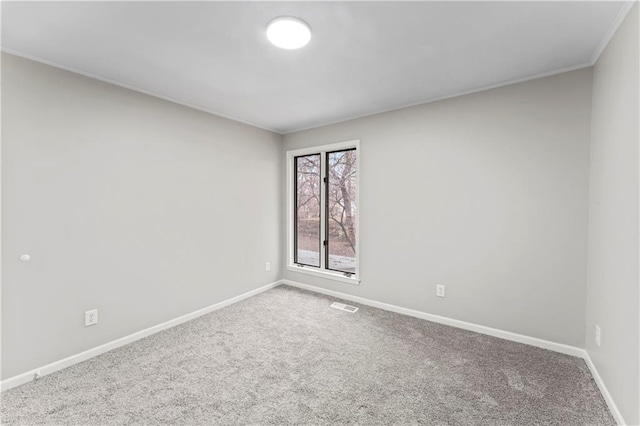 carpeted spare room with crown molding