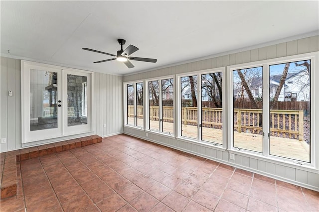 unfurnished sunroom with ceiling fan and a healthy amount of sunlight