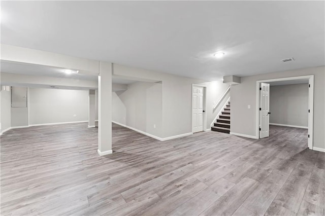 basement with light hardwood / wood-style flooring