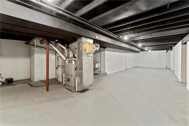 basement featuring sink and heating unit