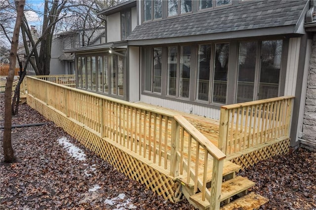 wooden deck with a sunroom