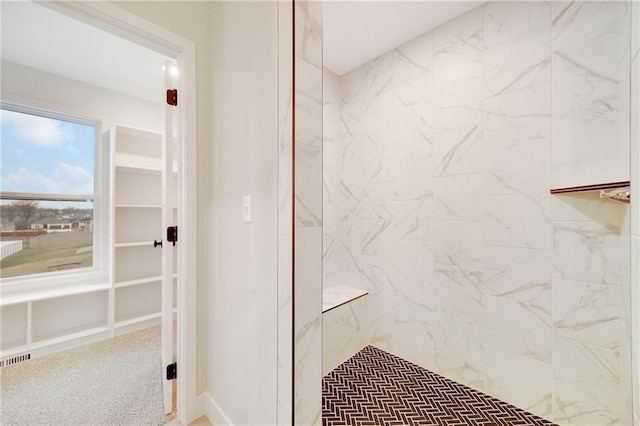 full bathroom with visible vents and tiled shower