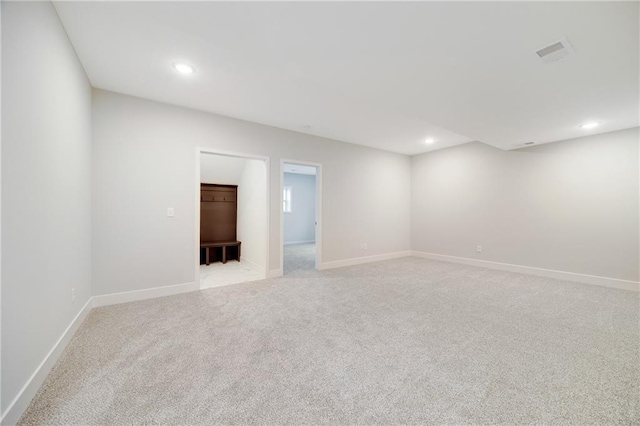 unfurnished room with visible vents, recessed lighting, baseboards, and light carpet