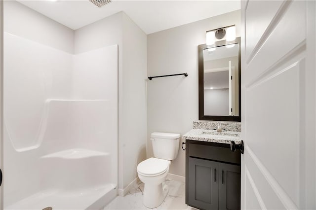 bathroom with marble finish floor, toilet, vanity, baseboards, and a shower
